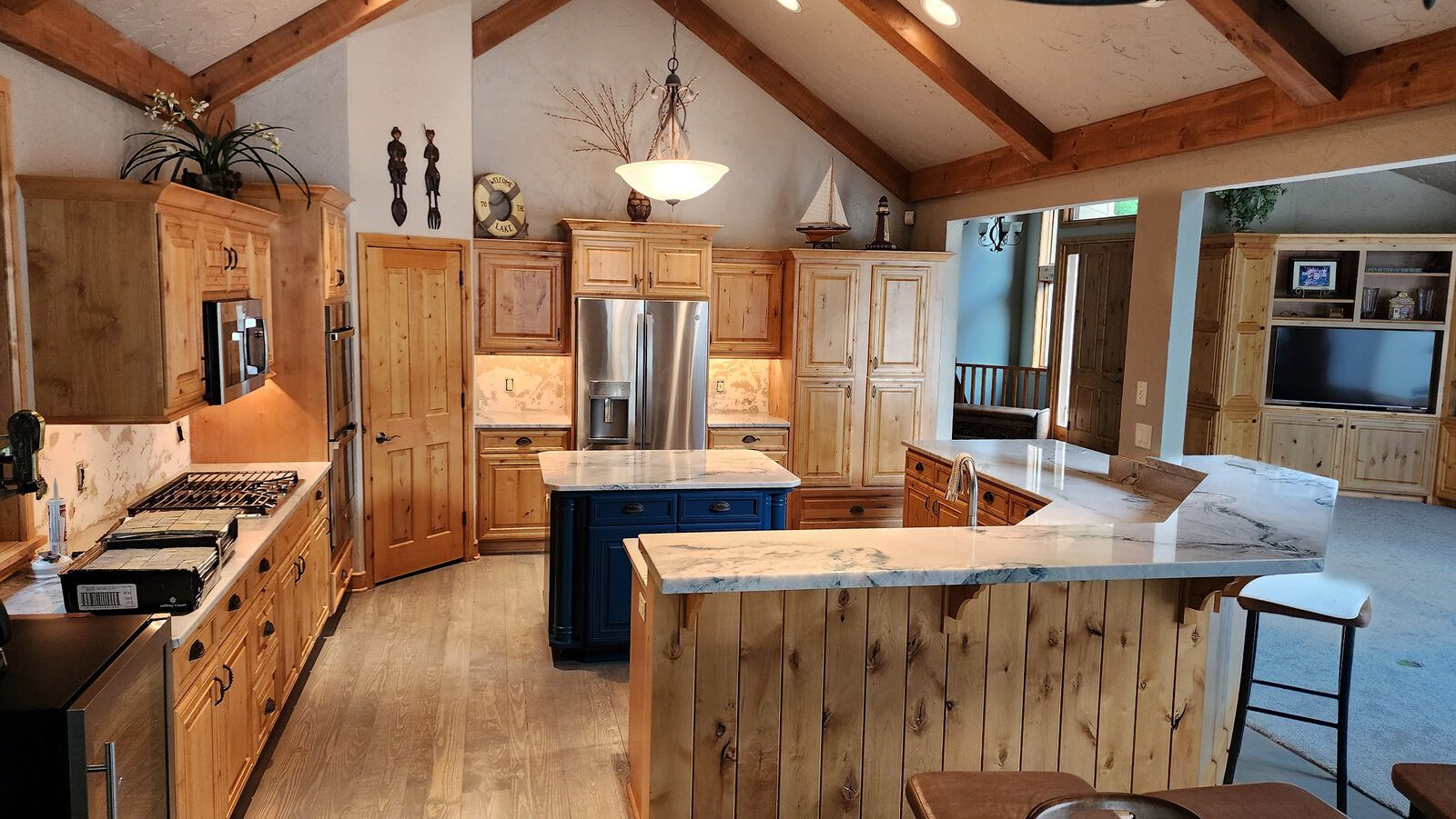 Granite kitchen with blue island in a log home